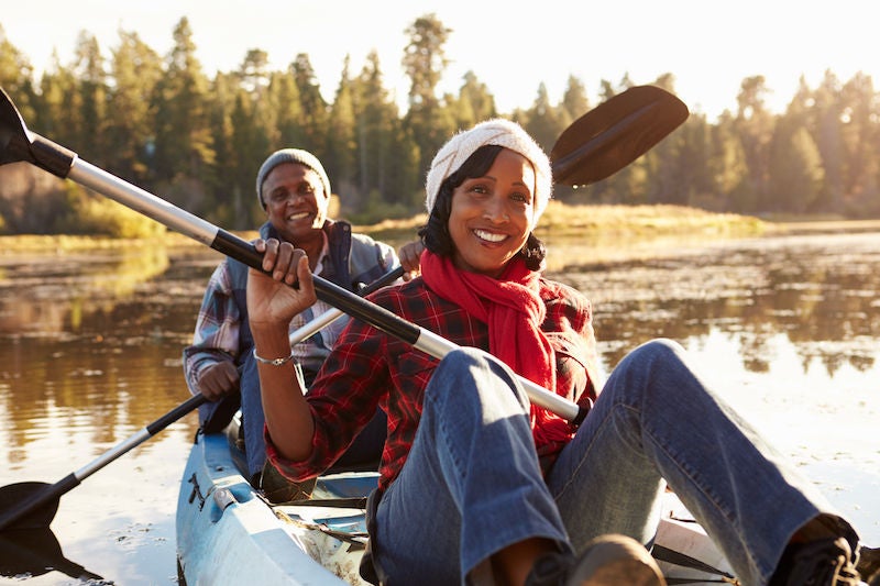 Senior African American Couple Rowing Kayak On Lake